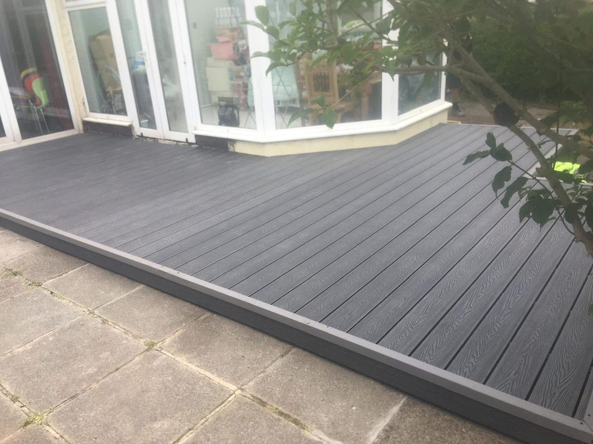 Slate grey composite decking outside a conservatory by Hedgeway Paving in Lancashire